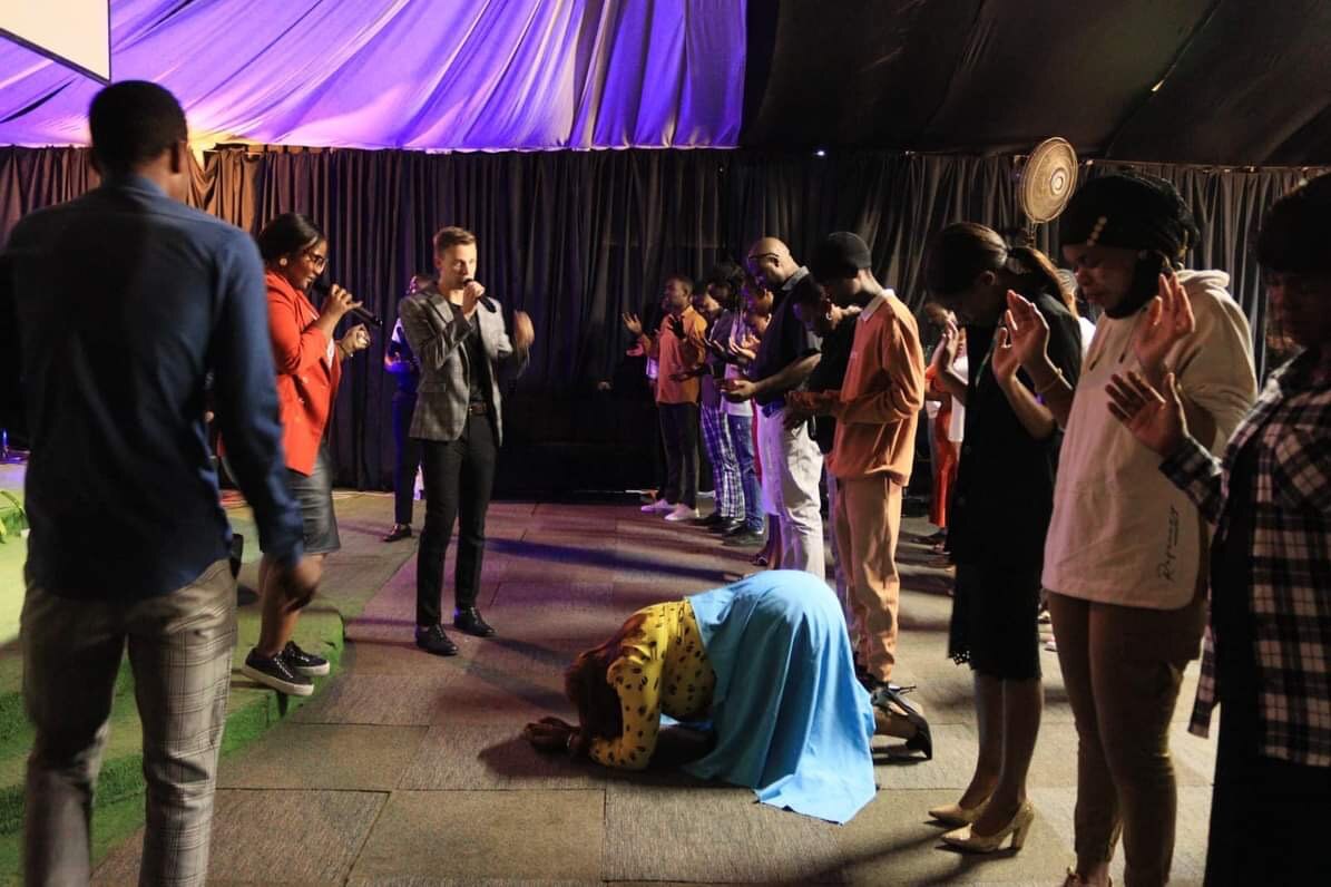 Armin and a ministry team praying with people during a church service
