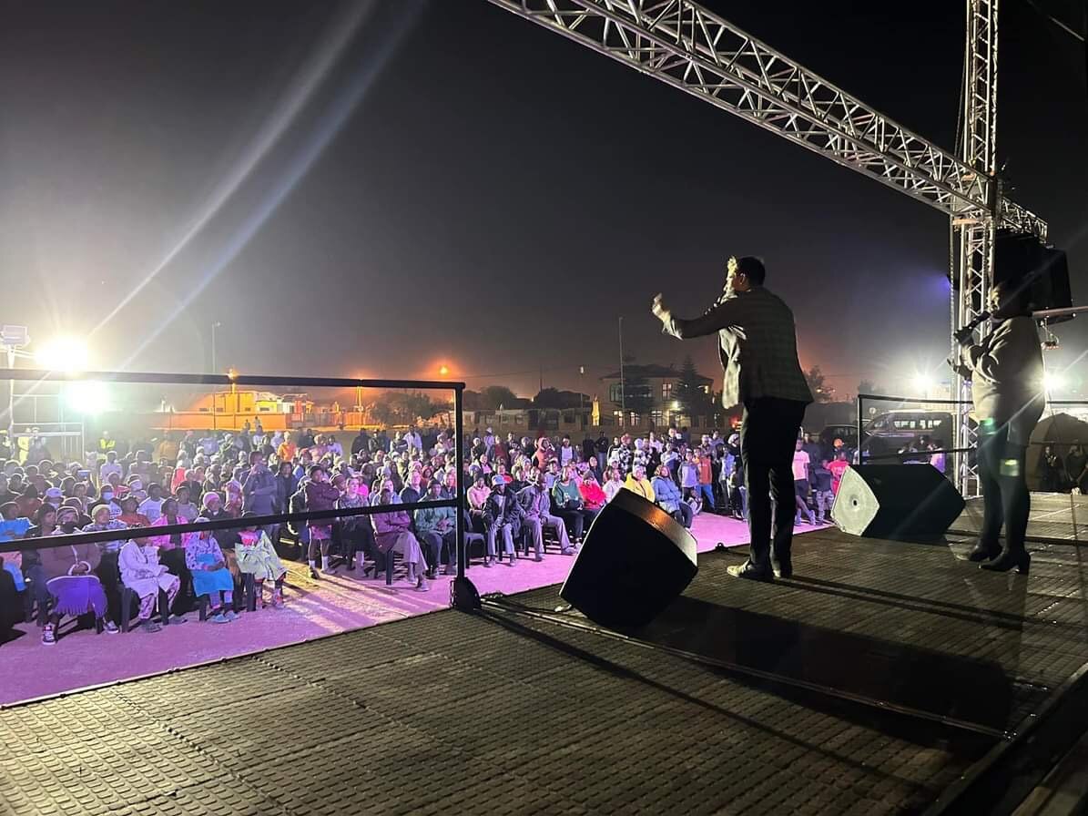 Armin speaking to an outdoor evening congregation in Pretoria